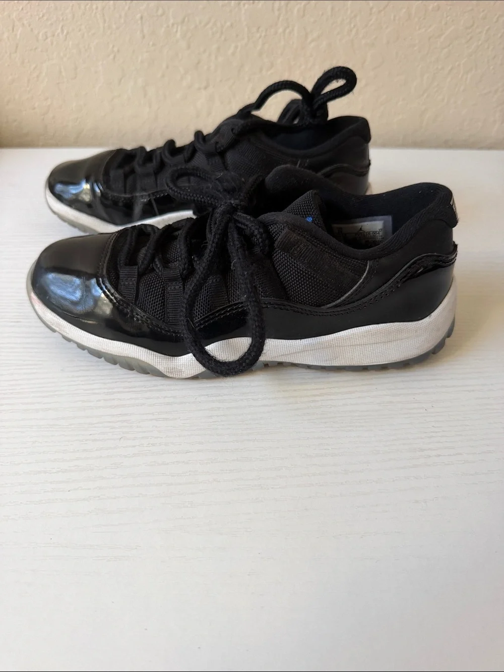 Jordan low 11’s Kids Black Basketball Sneakers with Blue Logo